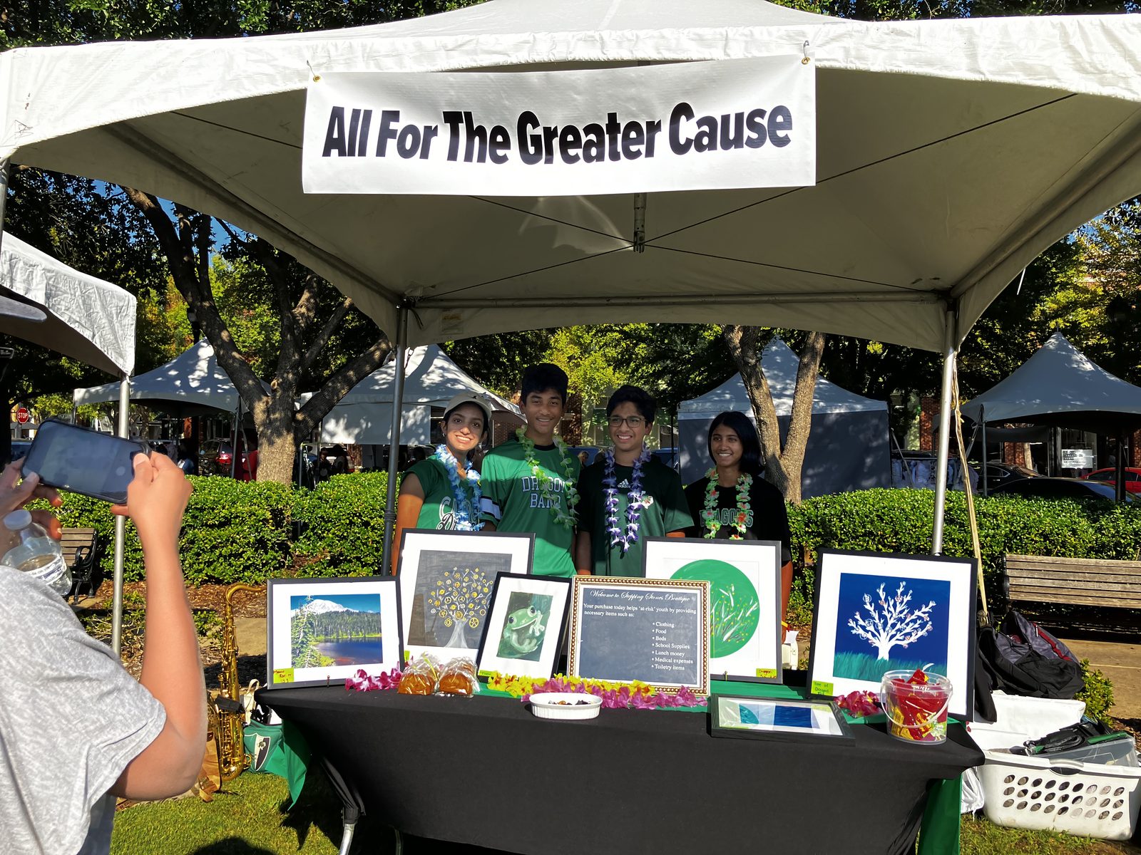 The team behind a display of framed prints at a community festival